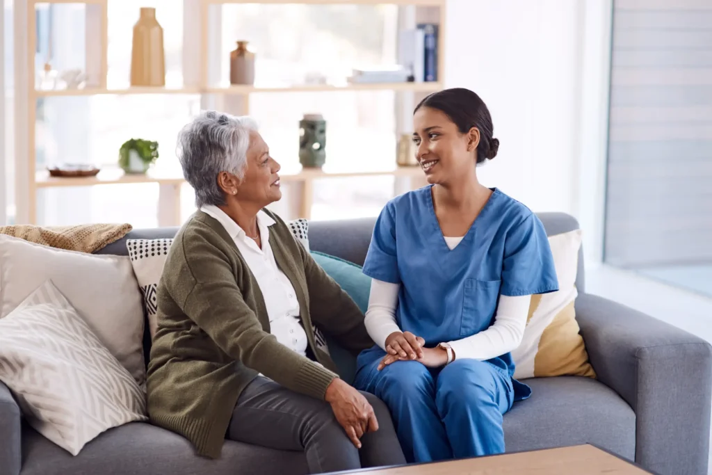 Caring in-home companion providing emotional support to elderly woman in Frederick County, Maryland
