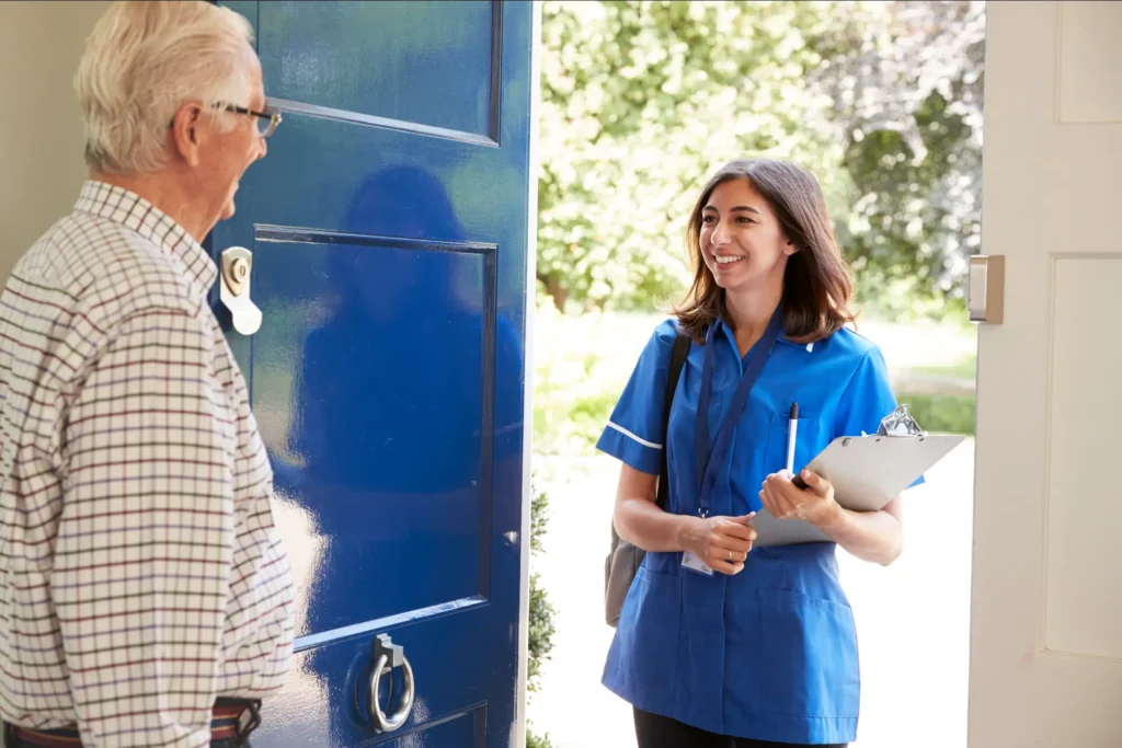 Warm greeting between in-home caregiver and senior man during a daily living support visit in Montgomery County, Maryland