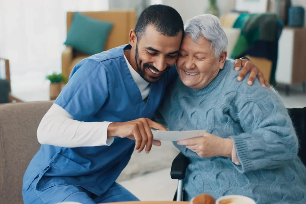 A warm moment between an in-home caregiver and a senior woman in a wheelchair, receiving compassionate care in Carroll County, Maryland.
