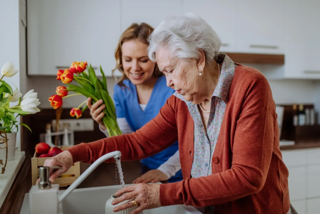 Enjoyable respite care activity: senior woman and caregiver tending to flowers in Montgomery County, Maryland