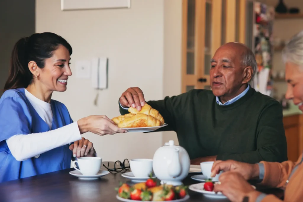Caring in-home nurse providing support to a senior in their kitchen in Carroll County, Maryland.
