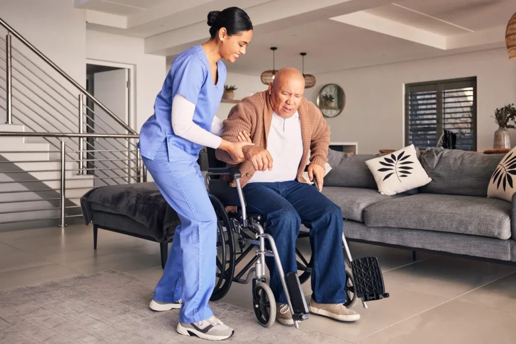 Compassionate in-home nurse assisting a man in a wheelchair within his home in Carroll County, Maryland.