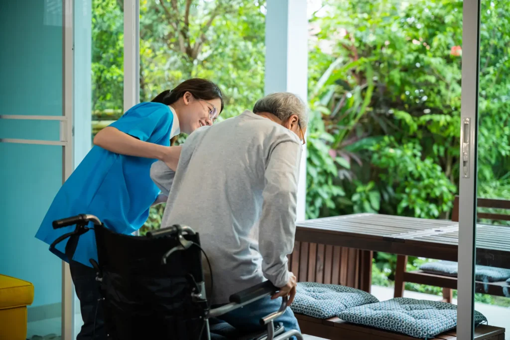 Compassionate in-home care providing mobility assistance to elderly man in a wheelchair in Montgomery County, Maryland