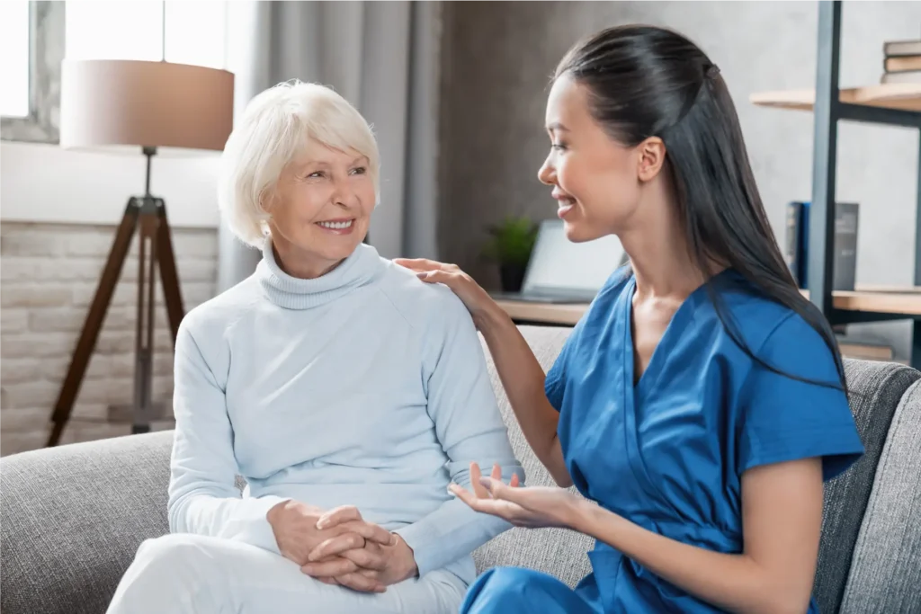 Caring nurse assisting an elderly woman in her Carroll County, Maryland home, providing personalized home care services.